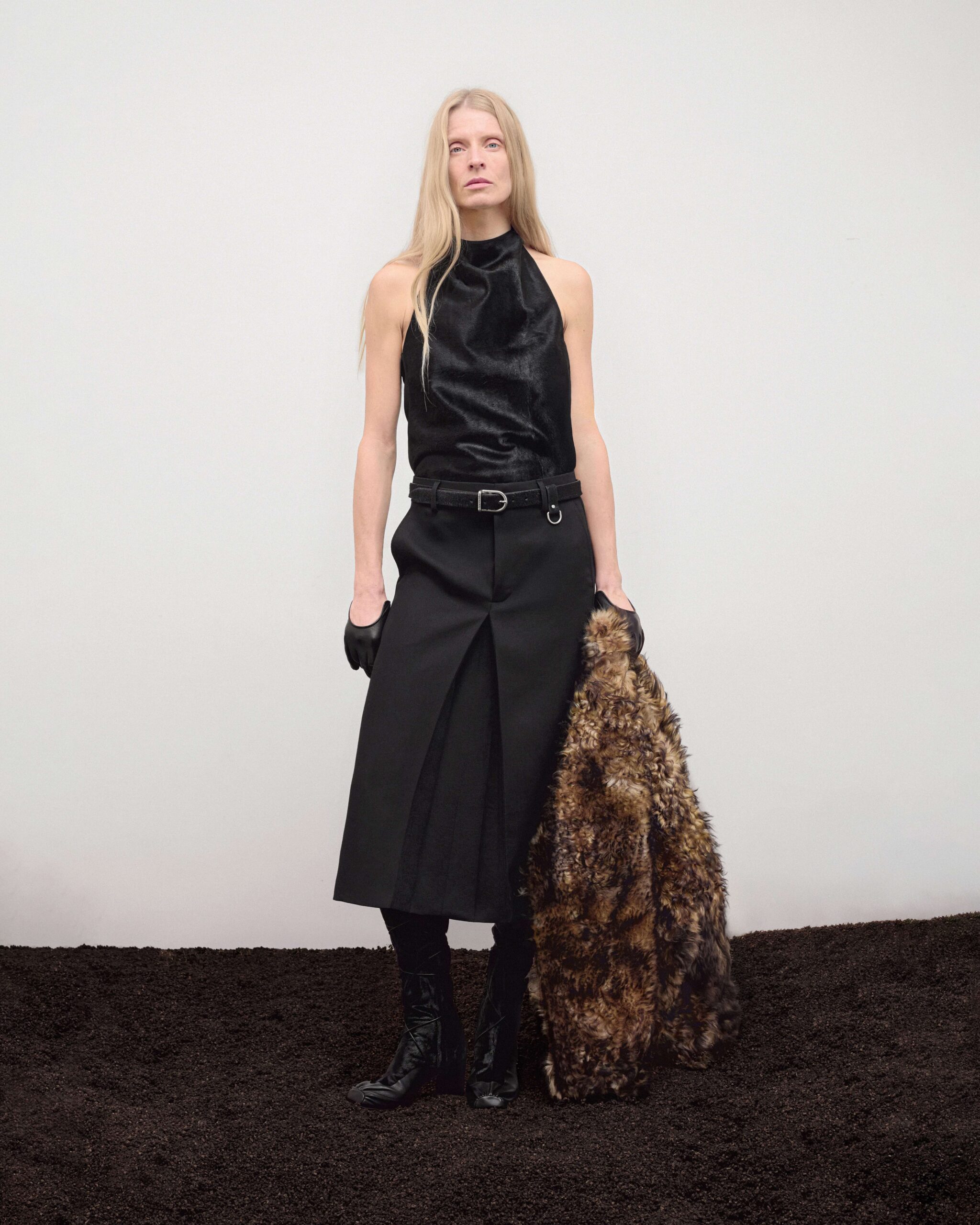 Pony hair top with belted black pleated midi skirt, murmasky shearling bomber, knee-high boots and black leather gloves, Durazzi Milano FW26