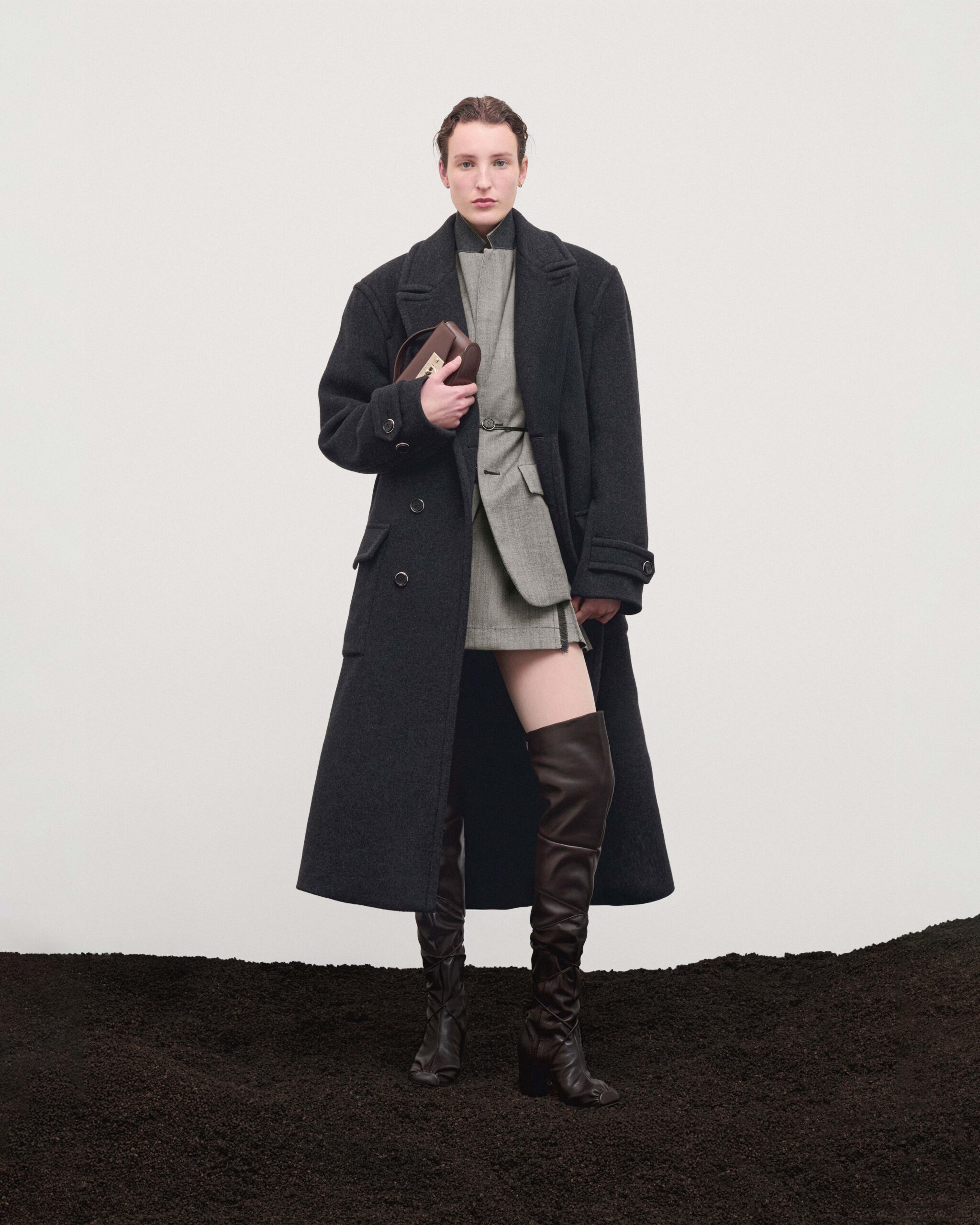 Double-breasted wool coat over blazer and wool mini skirt, brown over-the-knee boots and brown leather Mini Swing bag, Durazzi Milano FW26