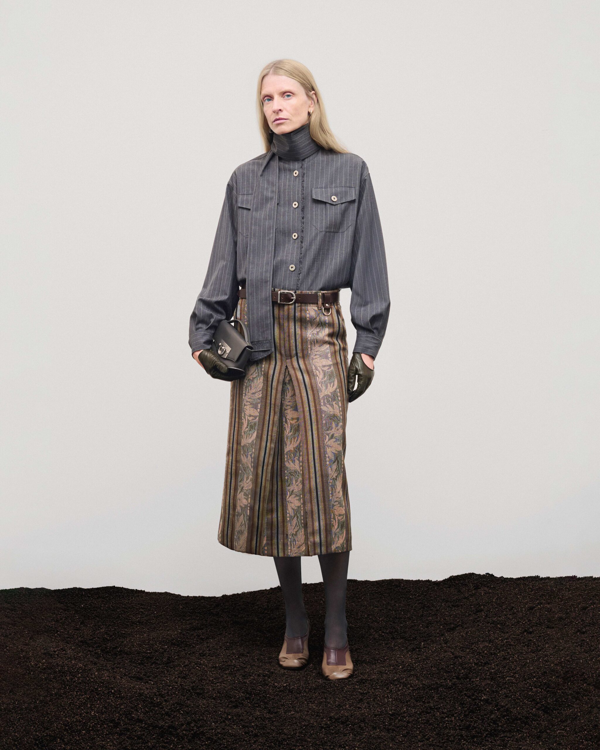 Pinstripe shirt with floral motif midi skirt and dark grey leather Mini Swing bag, Durazzi Milano FW26