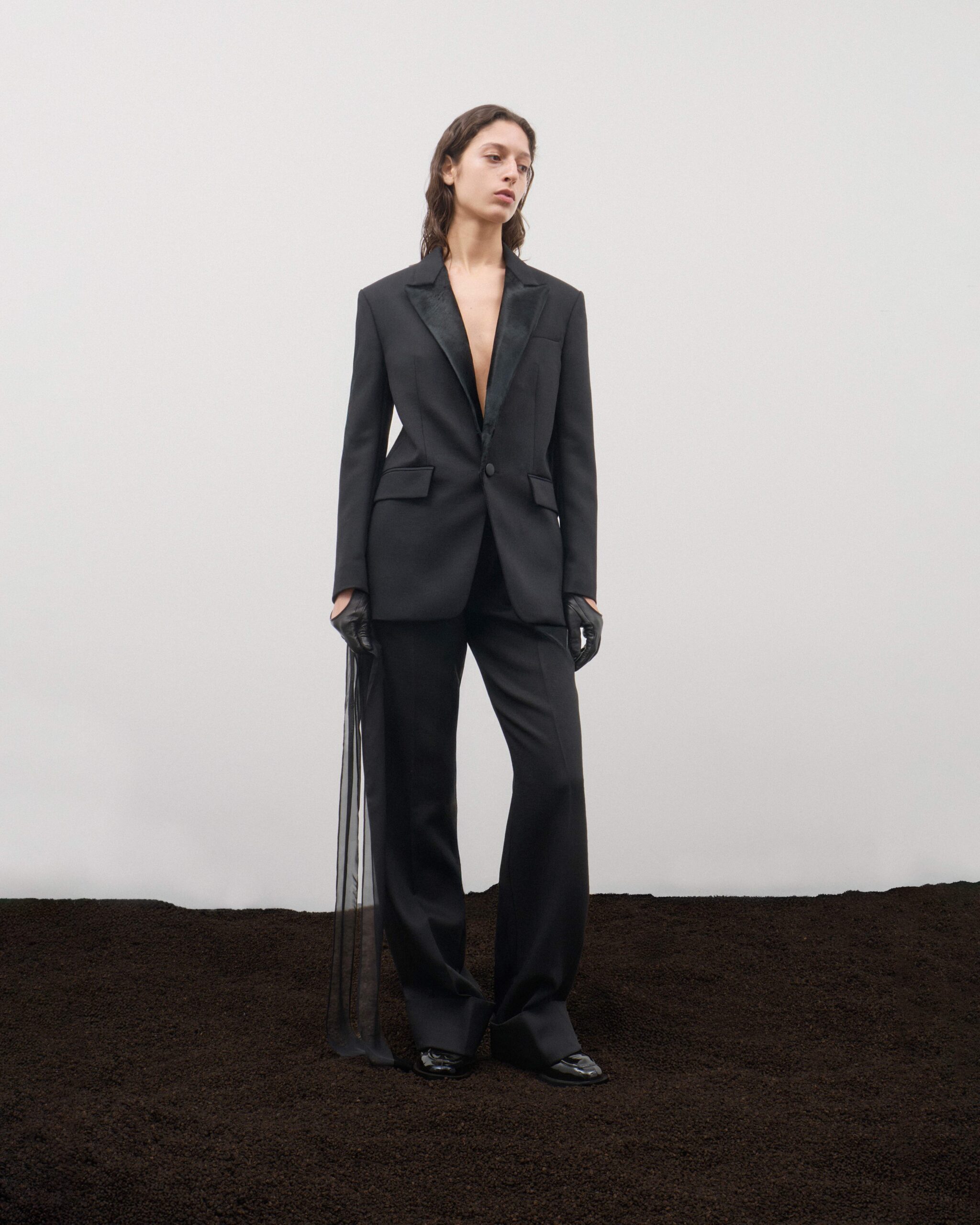 Single-breasted black blazer with black pony hair lapels, sheer tulle detail and tailored trousers, Durazzi Milano FW26
